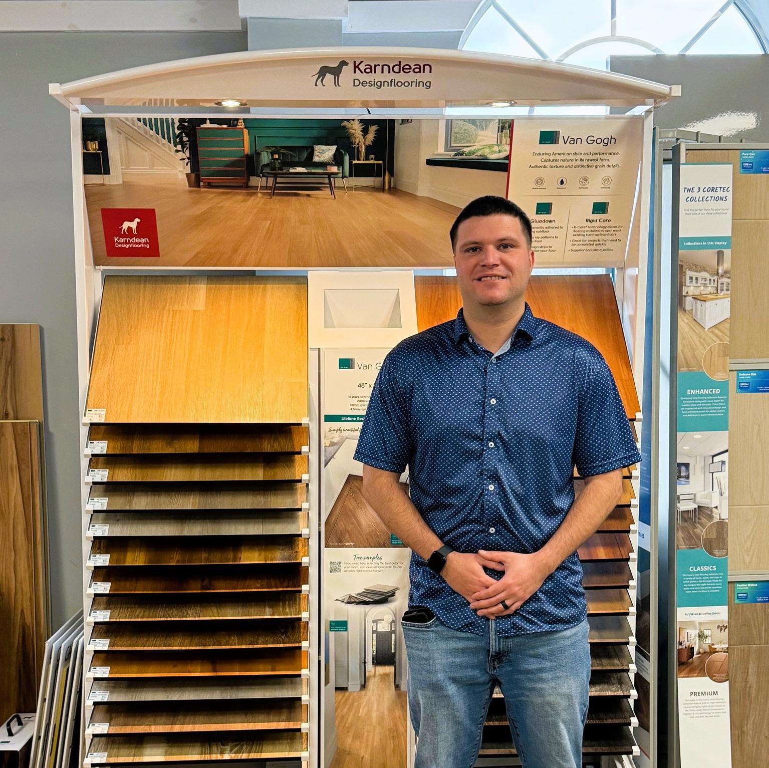 man standing in front of flooring samples