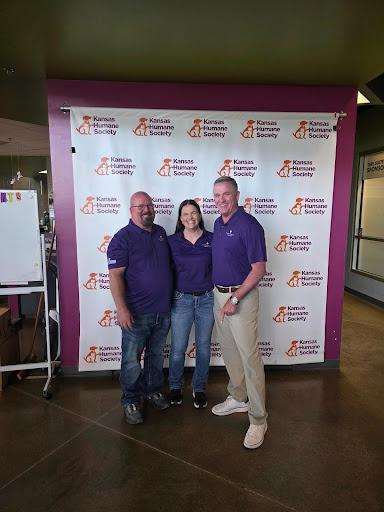 three people in front of backdrop