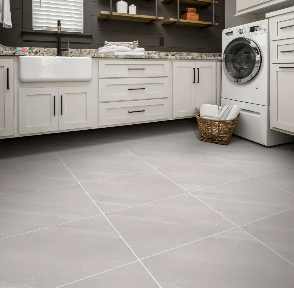 Laundry room with grey tile flooring