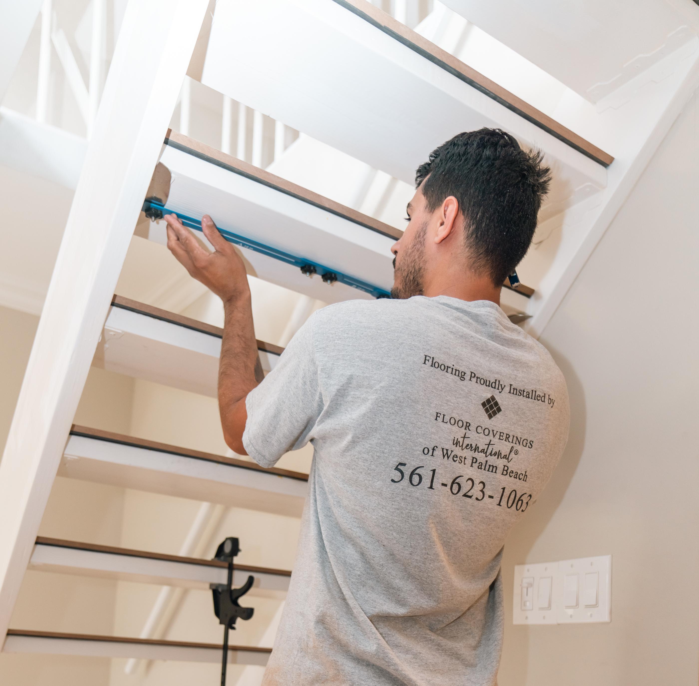 Laminate flooring installed on stairs, providing a modern wood-look finish.